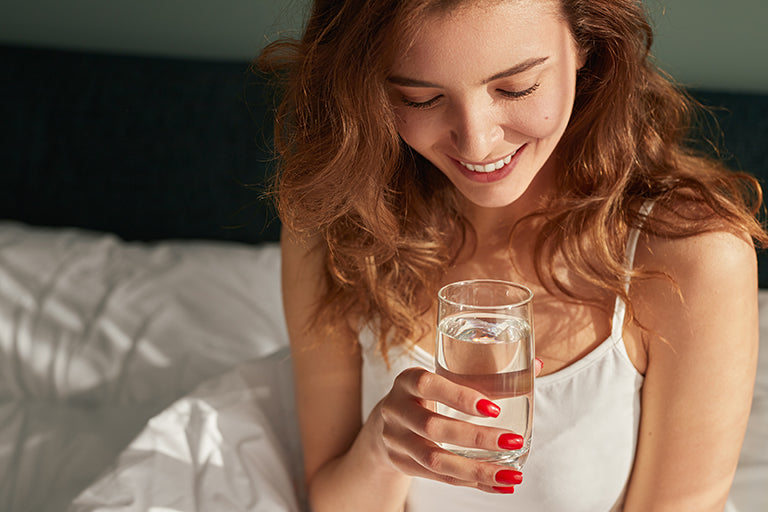 Image of woman shown with a glass of water